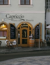 a restaurant with tables and chairs outside of it