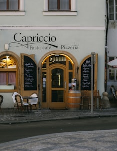 a restaurant with tables and chairs outside of it