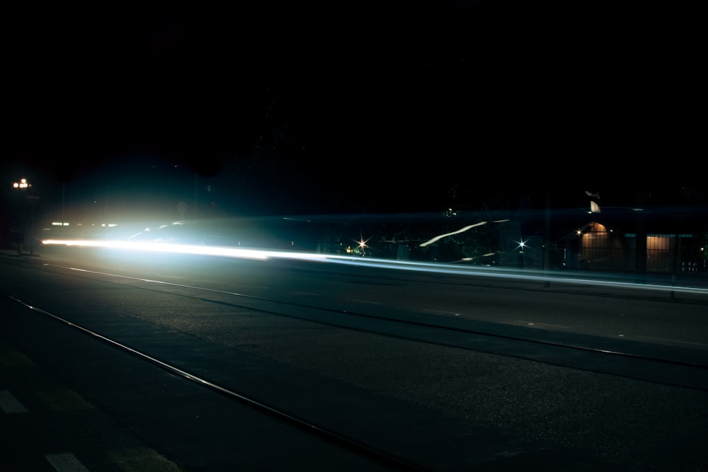 a car driving down a street at night