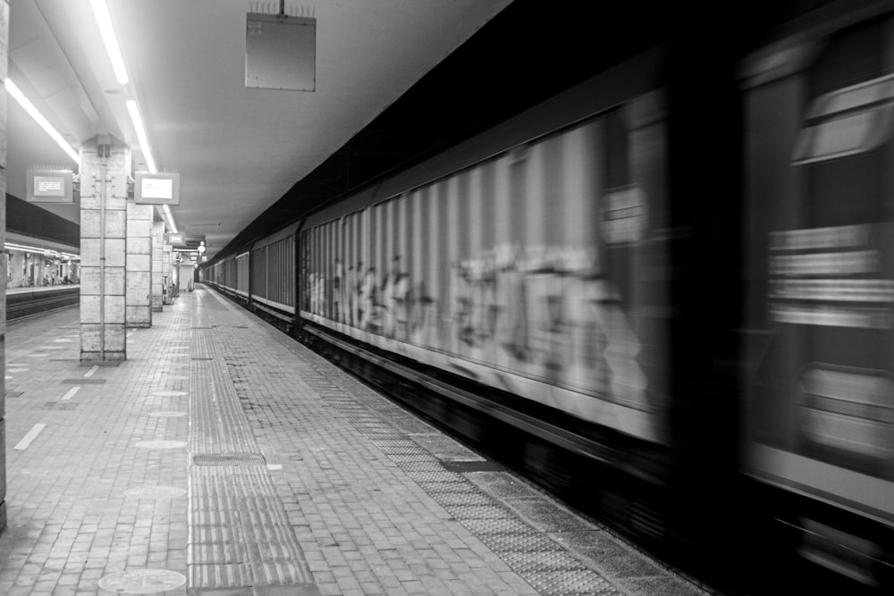 a black and white photo of a subway station