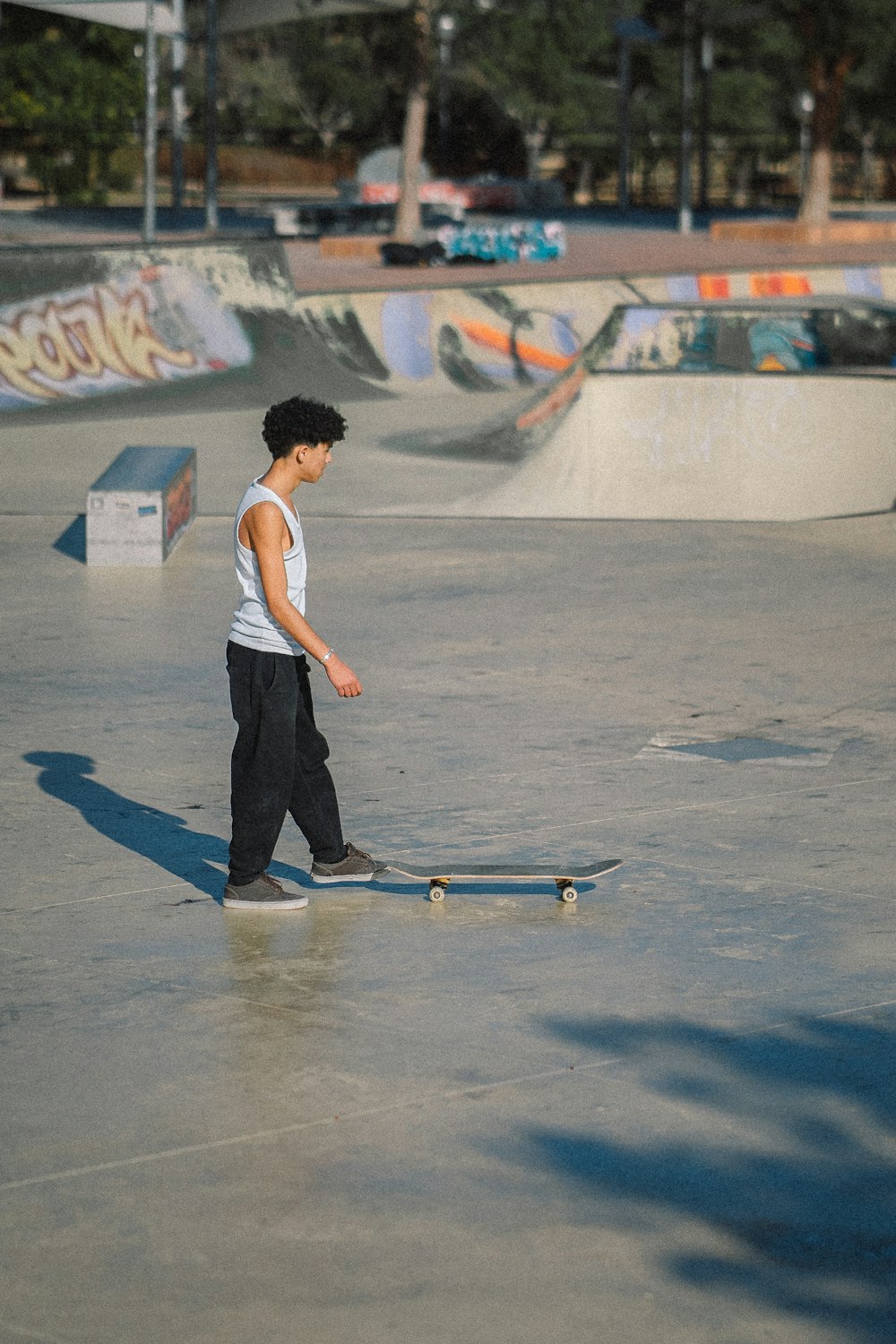 a young boy riding a skateboard at a skate park