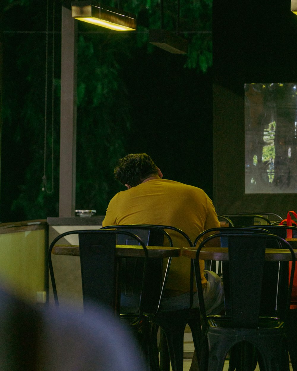 a person sitting at a table in a restaurant