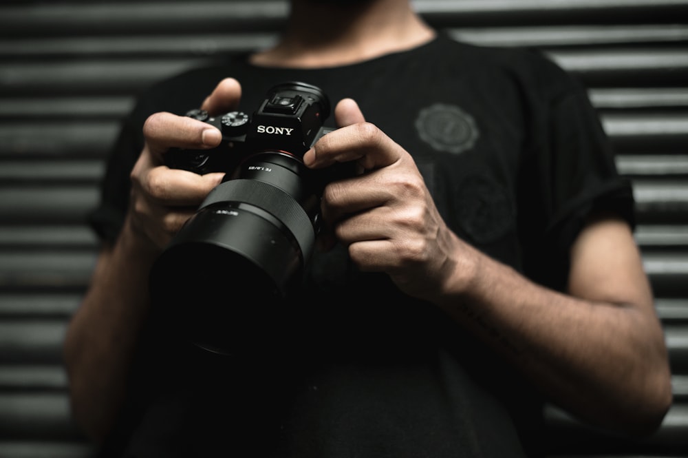 a man holding a camera in his hands