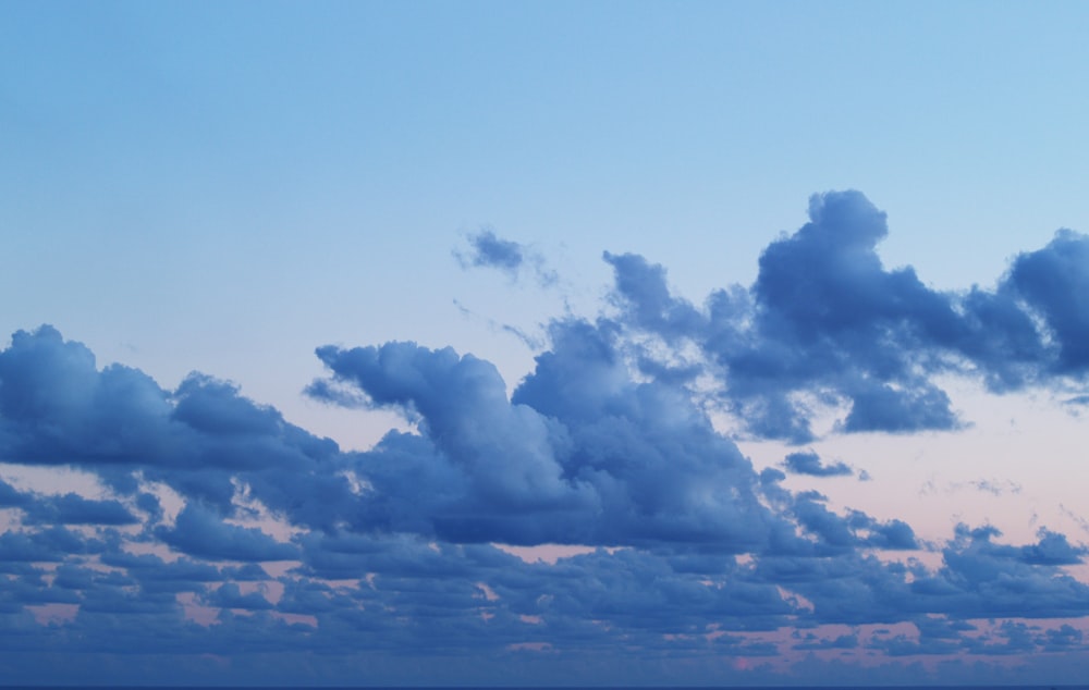 a plane flying in the sky over the ocean