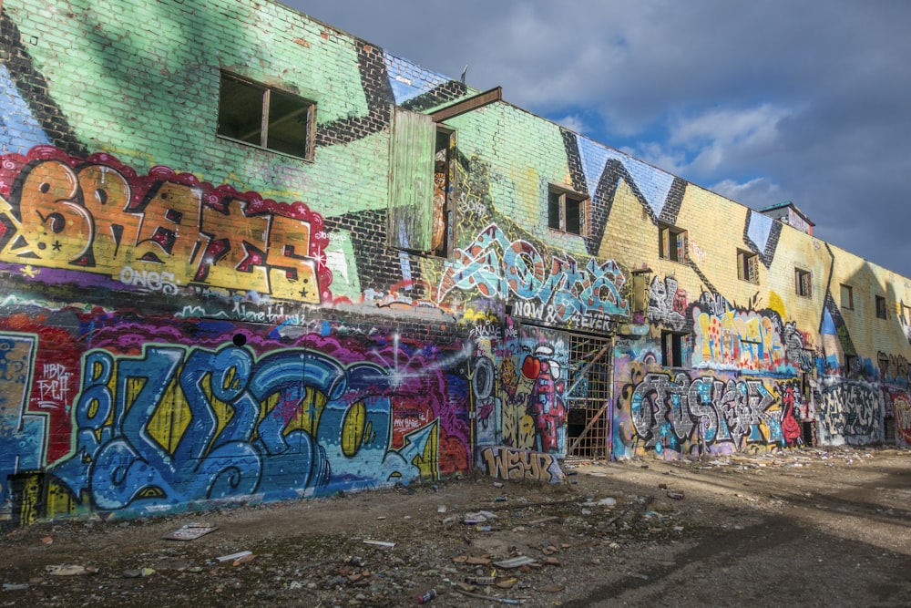 a bunch of graffiti on the side of a building