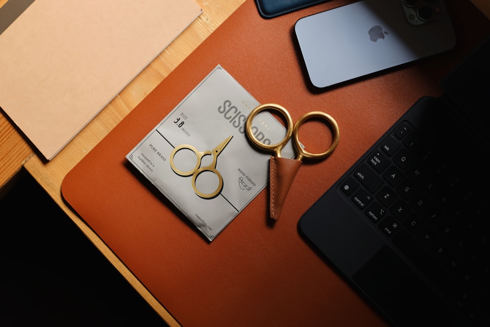a pair of gold scissors sitting on top of a table