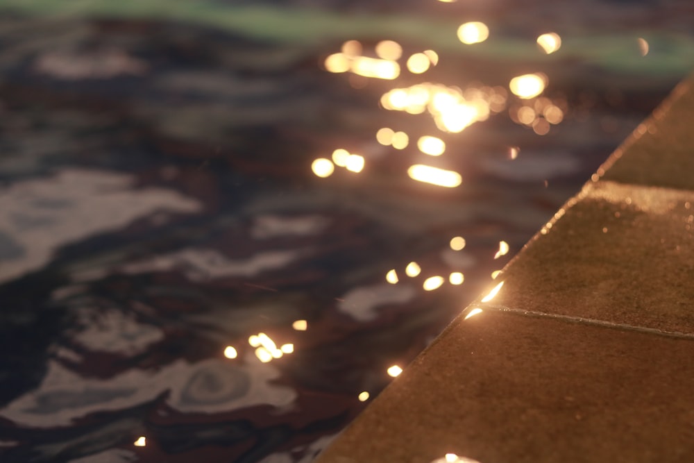 a close up of a brick wall near a body of water