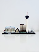 A miniature model of Las Vegas' skyline is displayed, featuring iconic structures such as a blue and white building, a small pyramid with a sphinx, a brown tower, and a tall tower with a red tip.