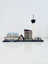 A miniature model of Las Vegas' skyline is displayed, featuring iconic structures such as a blue and white building, a small pyramid with a sphinx, a brown tower, and a tall tower with a red tip.