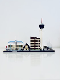 A miniature model of Las Vegas' skyline is displayed, featuring iconic structures such as a blue and white building, a small pyramid with a sphinx, a brown tower, and a tall tower with a red tip.