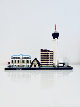 A miniature model of Las Vegas' skyline is displayed, featuring iconic structures such as a blue and white building, a small pyramid with a sphinx, a brown tower, and a tall tower with a red tip.