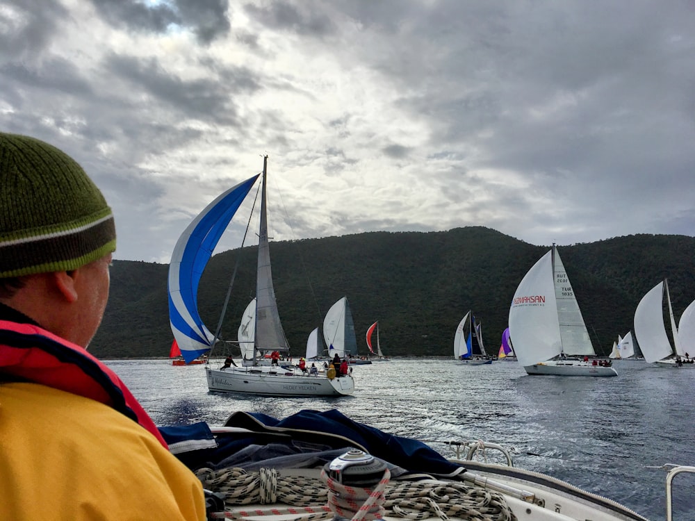 a group of sailboats sailing on a body of water