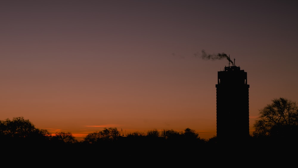 a tall tower with smoke coming out of it