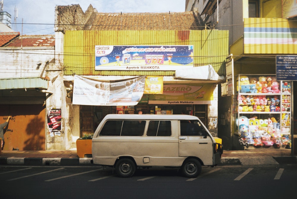 a white van parked in front of a store