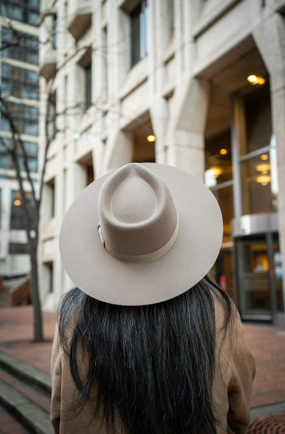 a person wearing a hat walking down a street