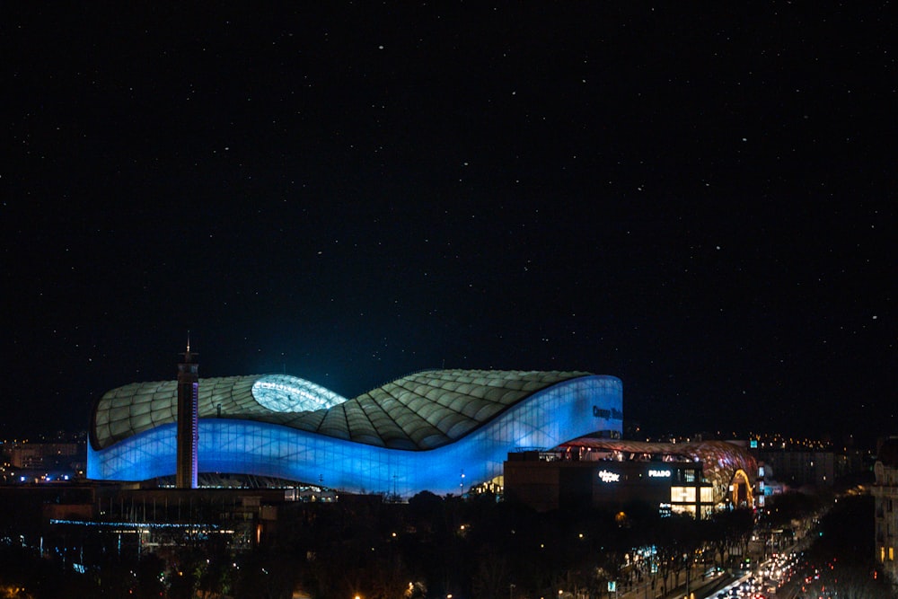a night view of a building with a curved roof