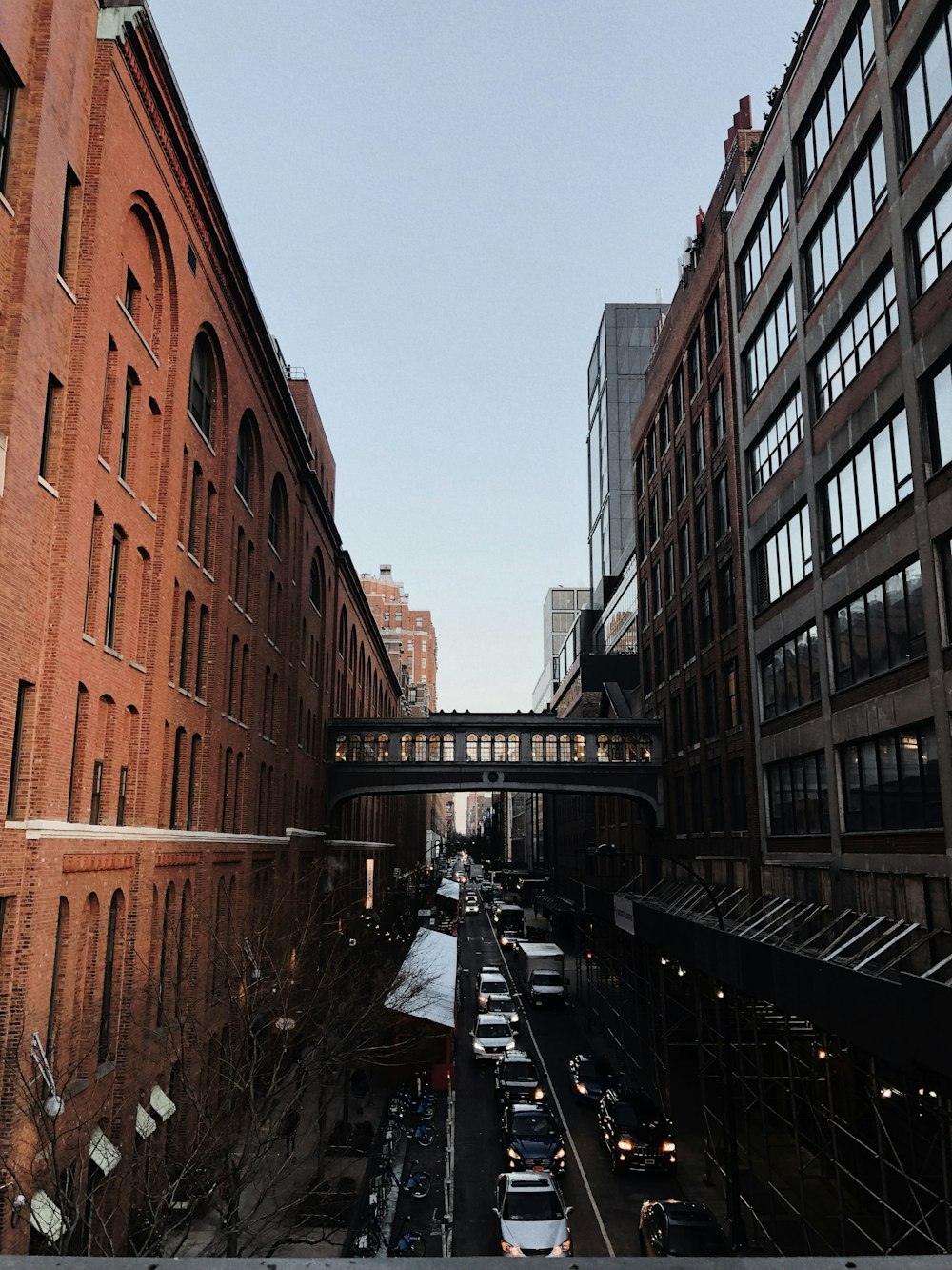 a city street filled with lots of traffic next to tall buildings