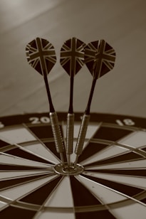 three darts in the center of a dart