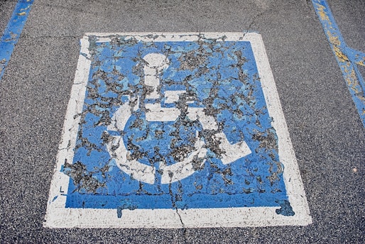 a blue and white sign for ada parking