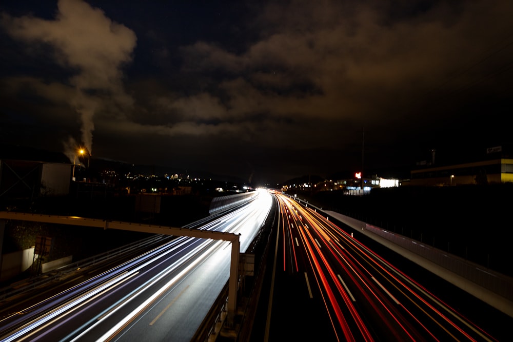 a long exposure photo of a highway at night