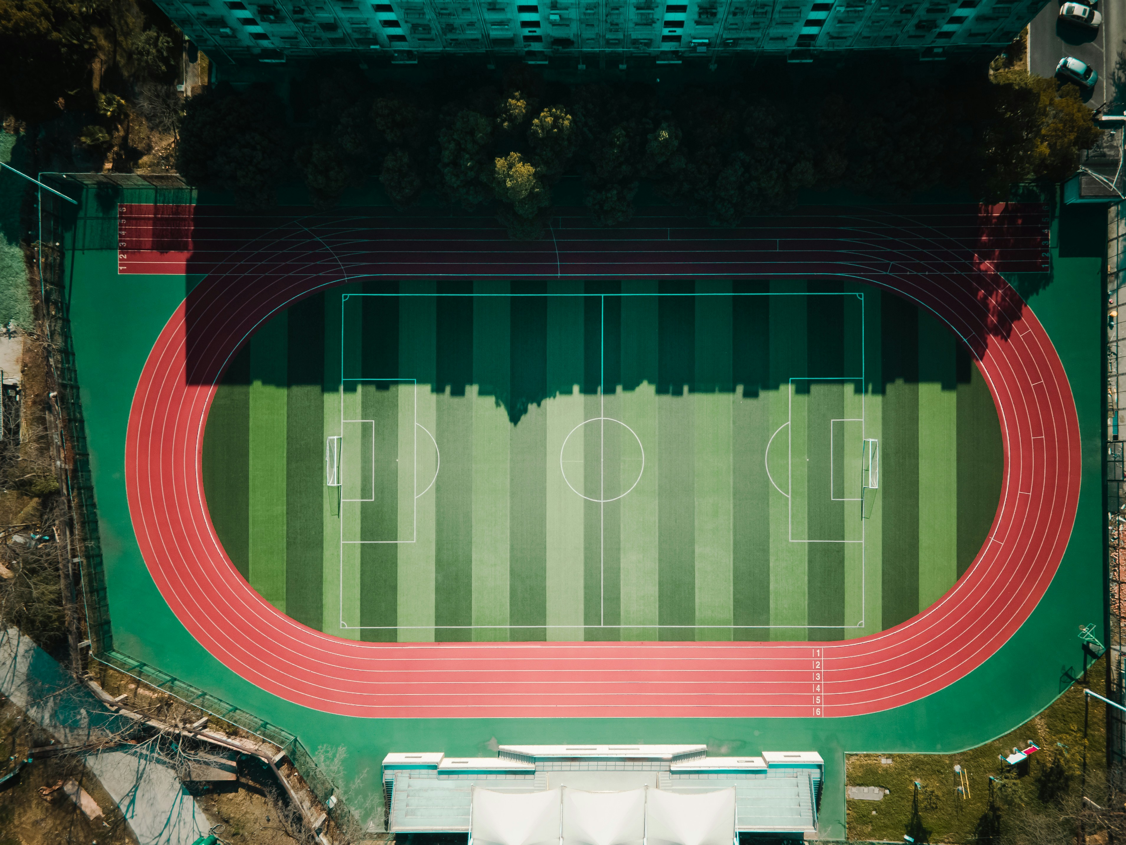 an aerial view of a stadium with a red track