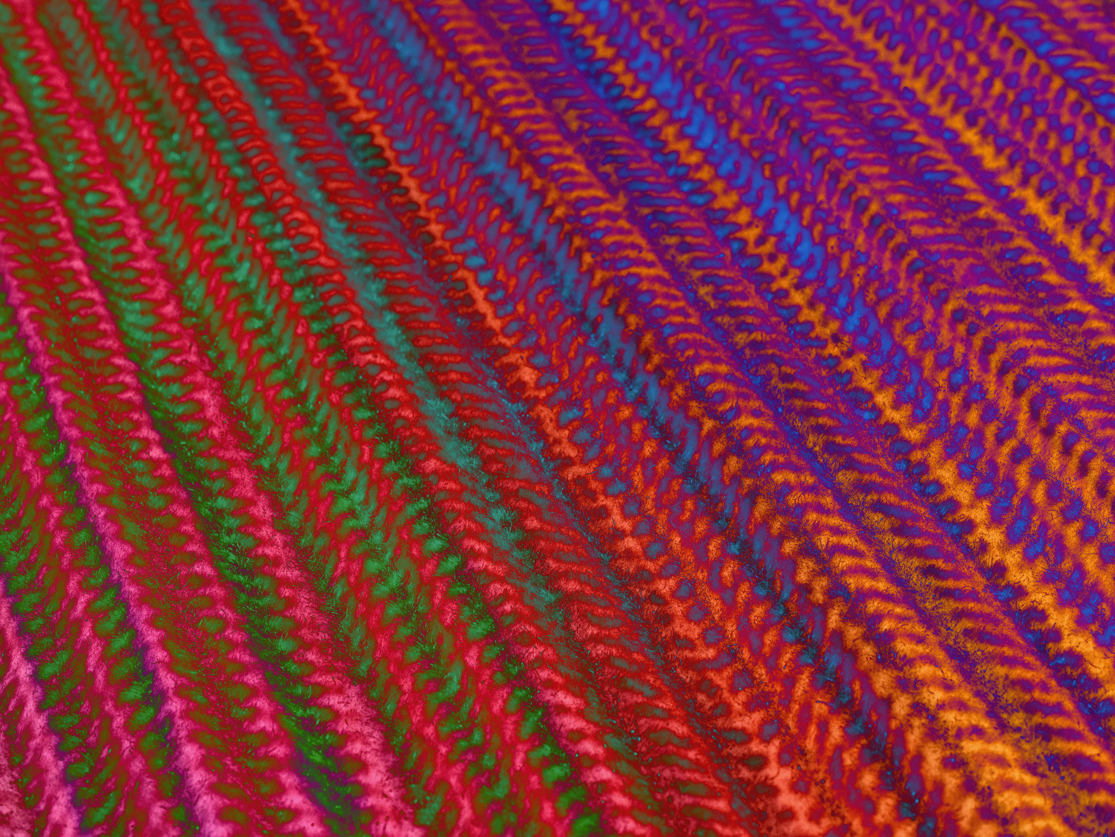 a close up of a multicolored knitted blanket