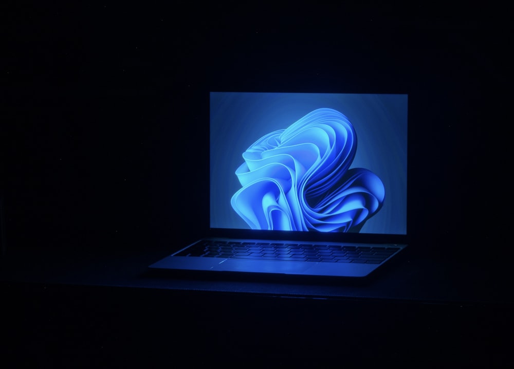 a macbook air laptop in a dark room