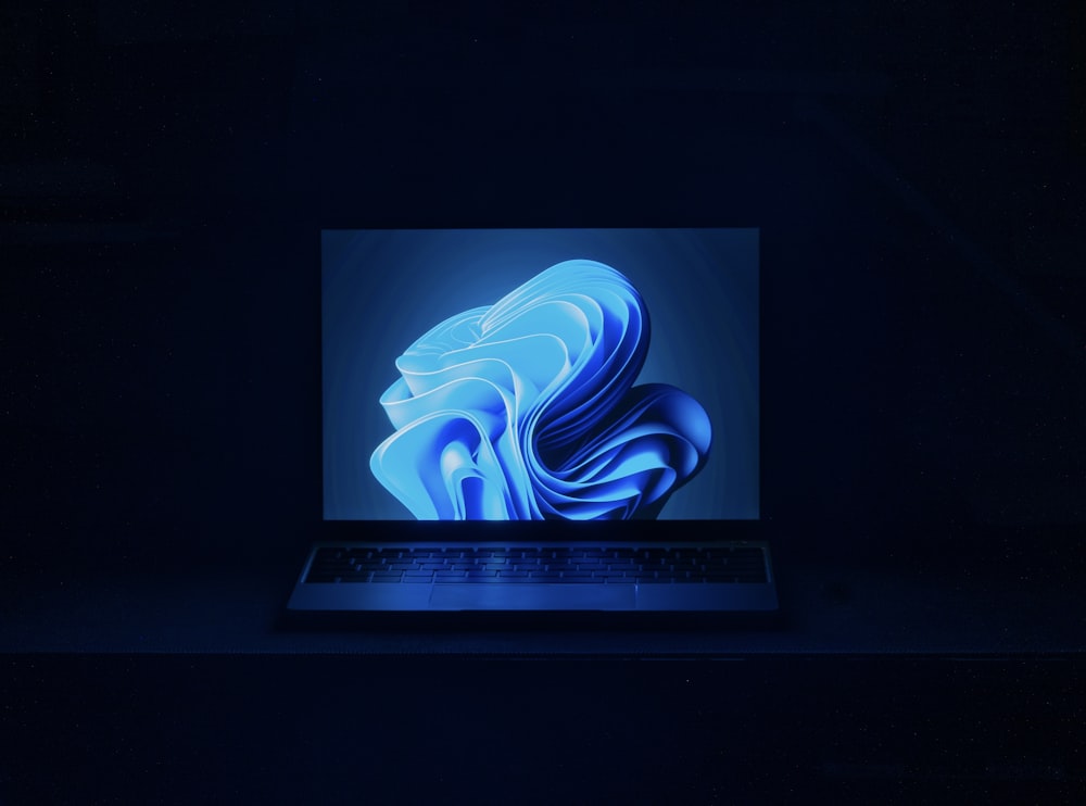 a macbook air laptop in a dark room