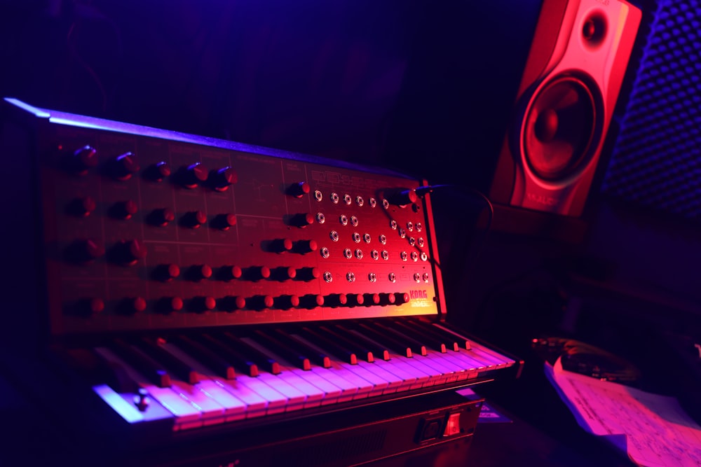 a keyboard and a speaker in a dark room