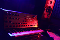 A keyboard and a speaker in a dark room