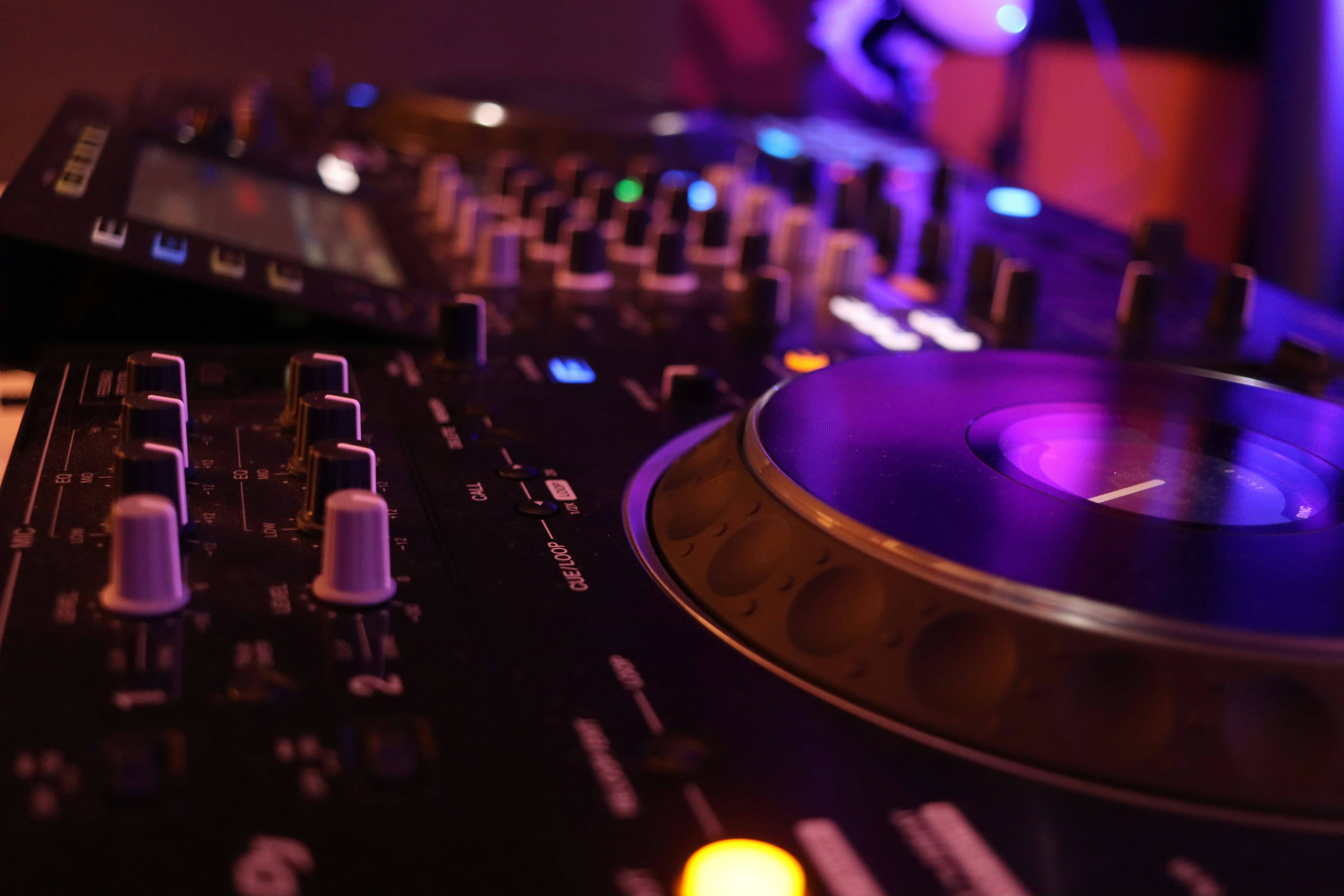 a close up of a dj's turntable and mixer