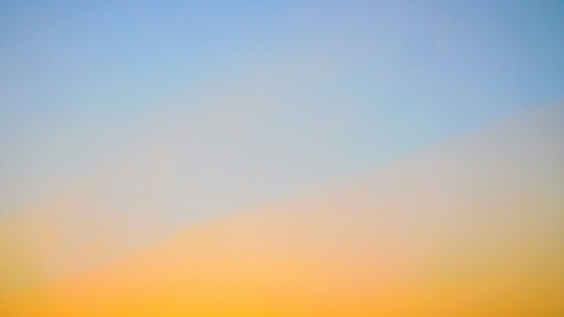 a plane flying in the sky at sunset
