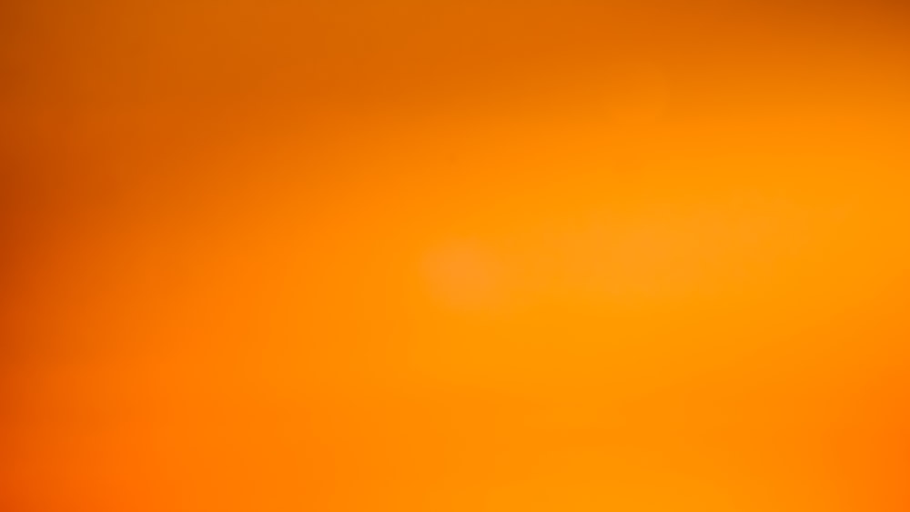 an orange and yellow background with a blurry effect