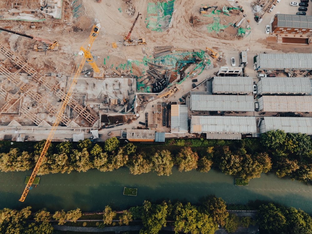 an aerial view of a construction site next to a river