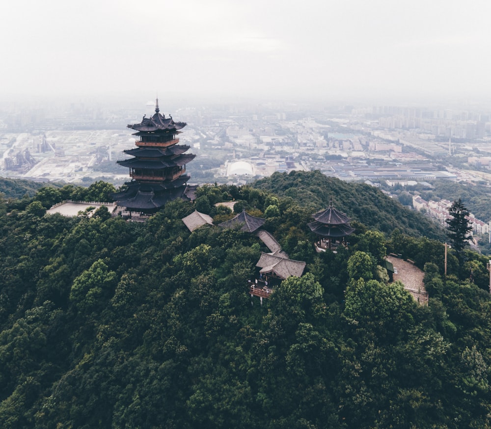 a tall tower sitting on top of a lush green hillside