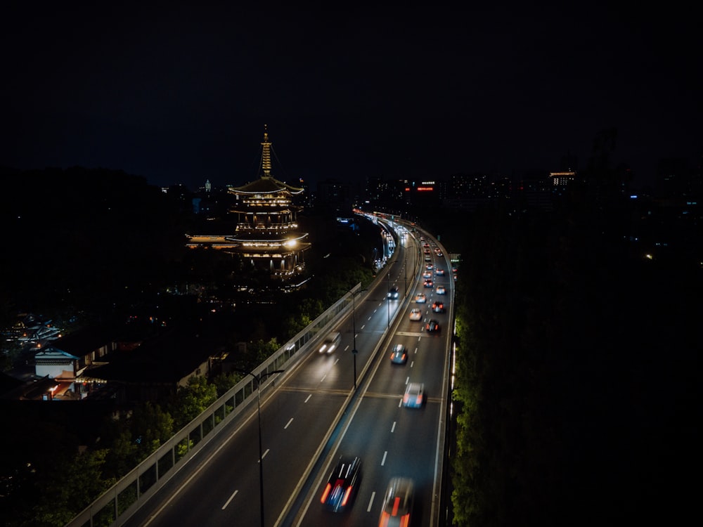 a night time view of a highway with a lot of traffic