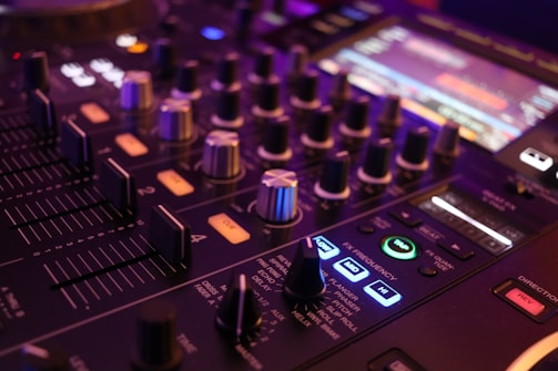 a close up of a sound board with buttons and knobs