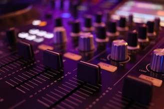 a close up of a sound board with knobs
