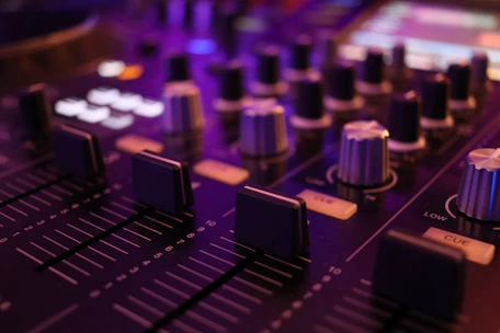 a close up of a sound board with knobs