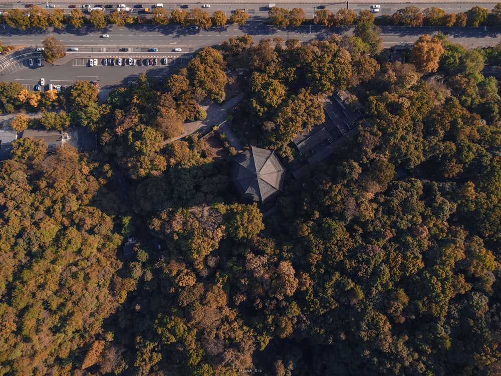 an aerial view of a parking lot surrounded by trees