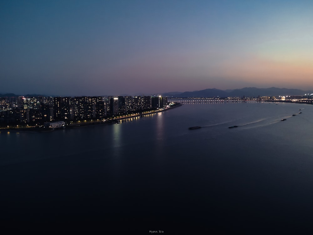 a large body of water with a city in the background