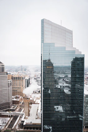 High-rise building in a bustling urban area with modern architecture and glass facades.