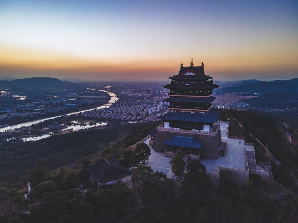 a tall tower sitting on top of a lush green hillside