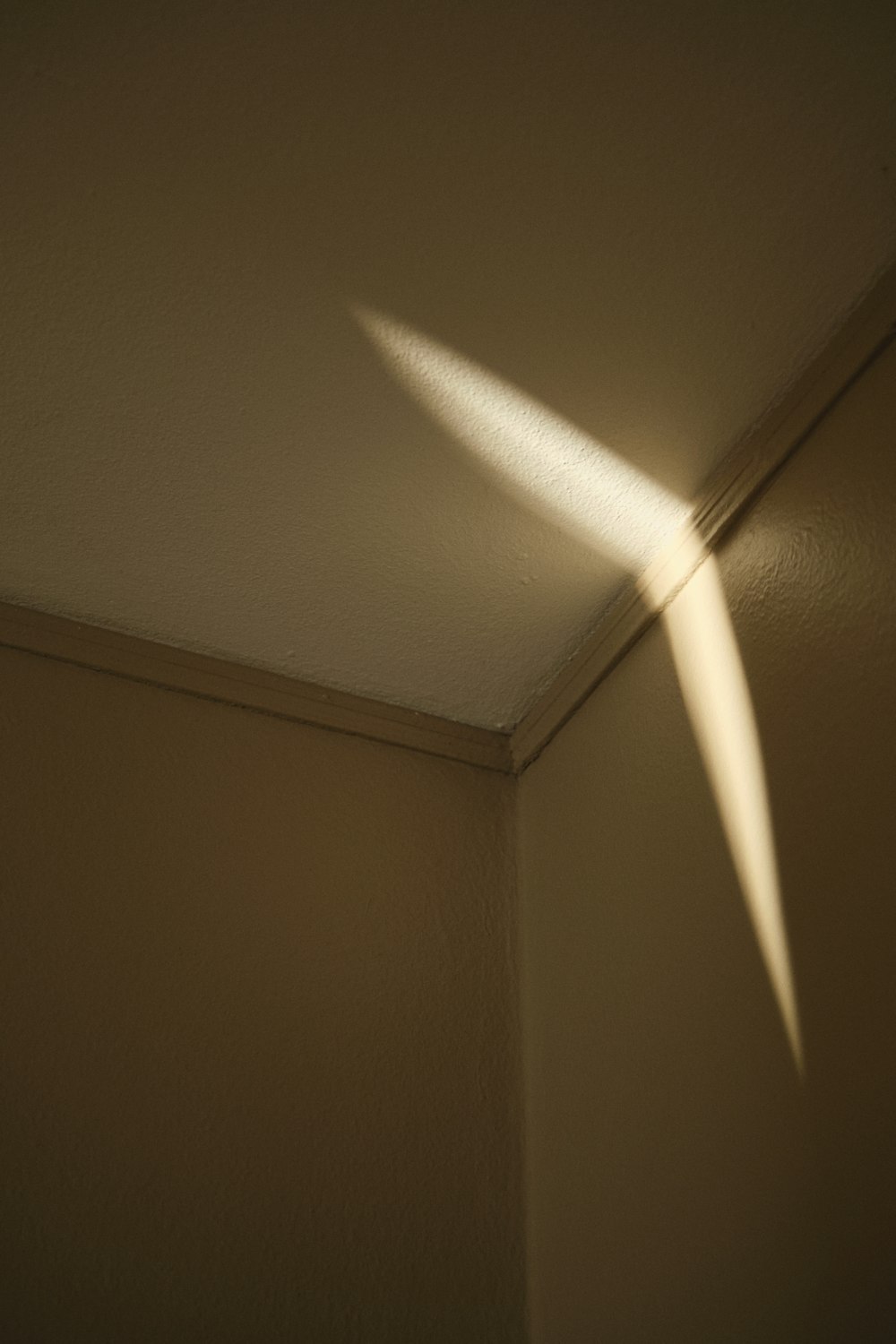 the shadow of a light shining on a wall