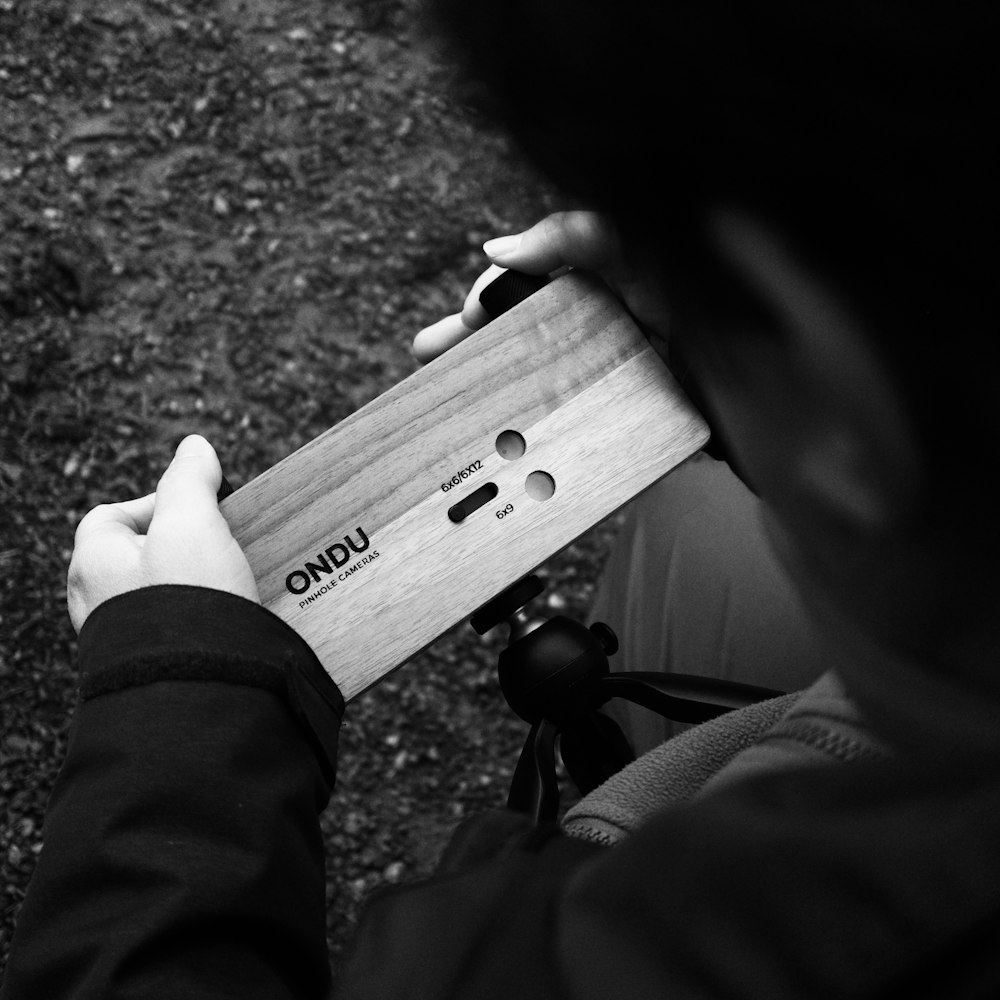 a person holding a wooden object in their hands