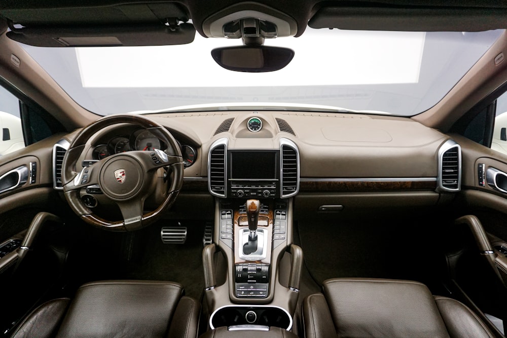 the inside of a car with a steering wheel and dashboard