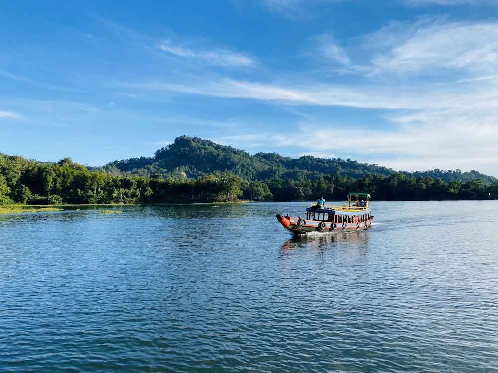 a boat on a lake with a mountain in the background