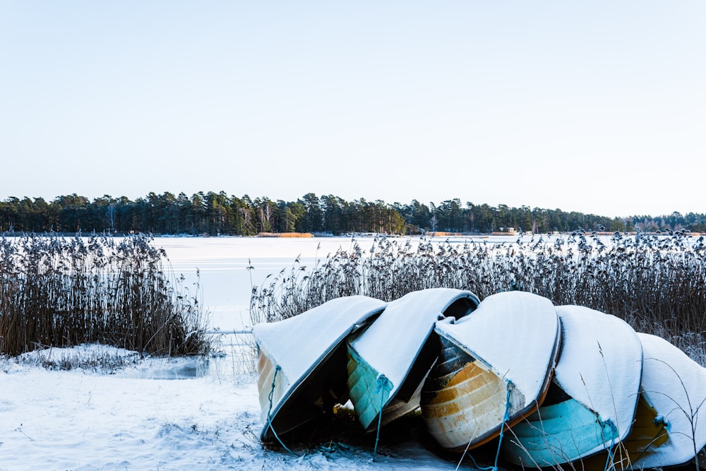 a bunch of boats that are sitting in the snow