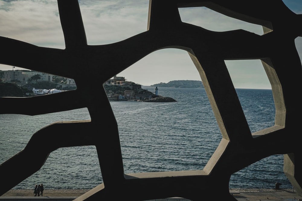 a view of a body of water through a sculpture