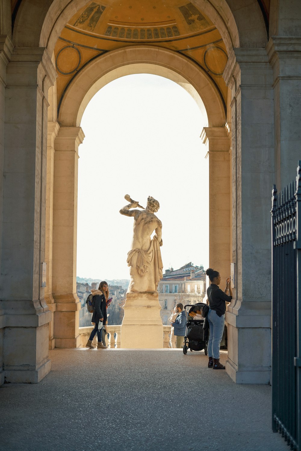 a group of people standing around a statue